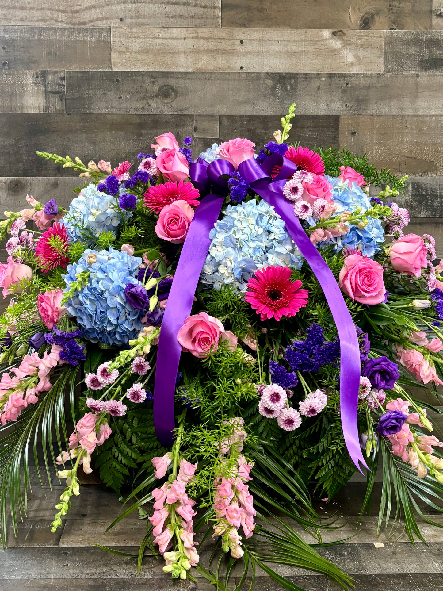 Jewel toned casket spray