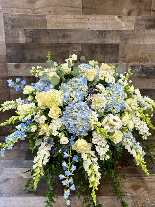 Blue and white casket spray
